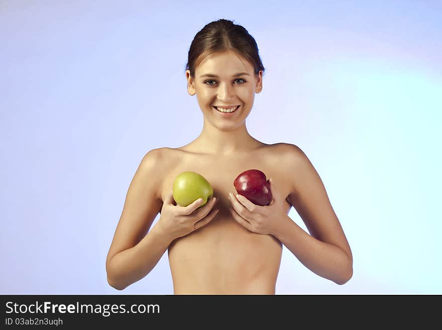 Topless smiling beautiful woman with two apples