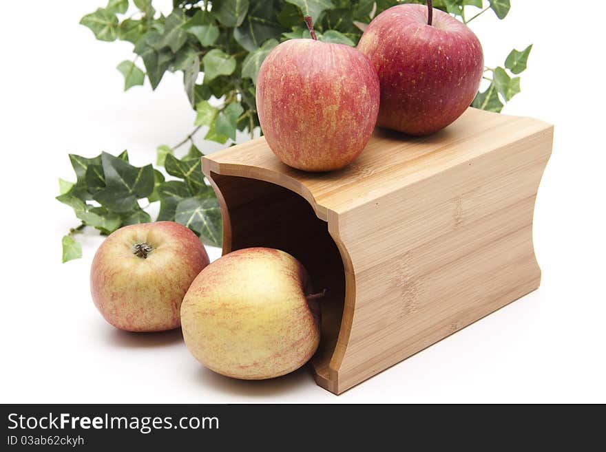 Red apples onto receptacles with ivy