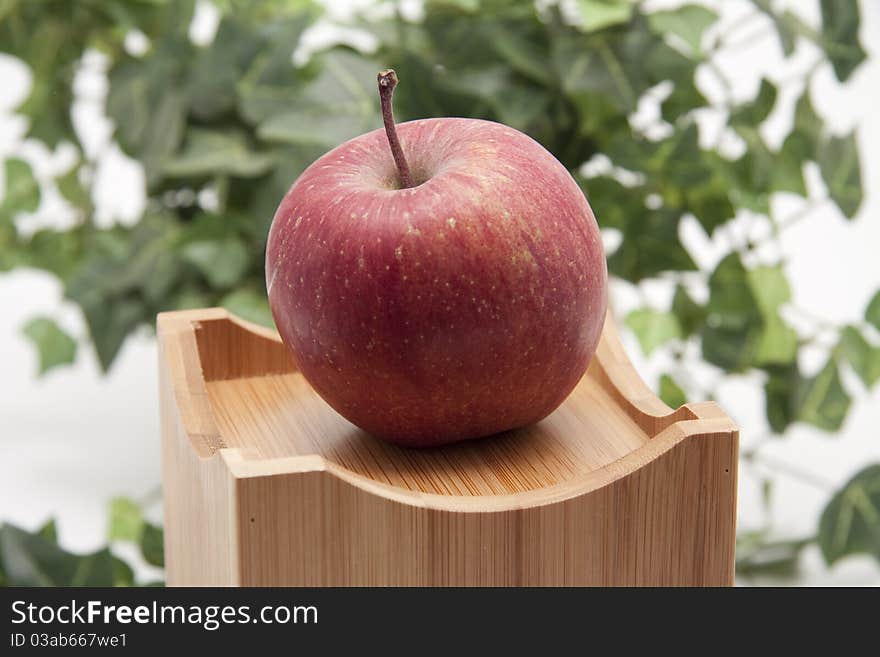 Red apple onto receptacles with ivy