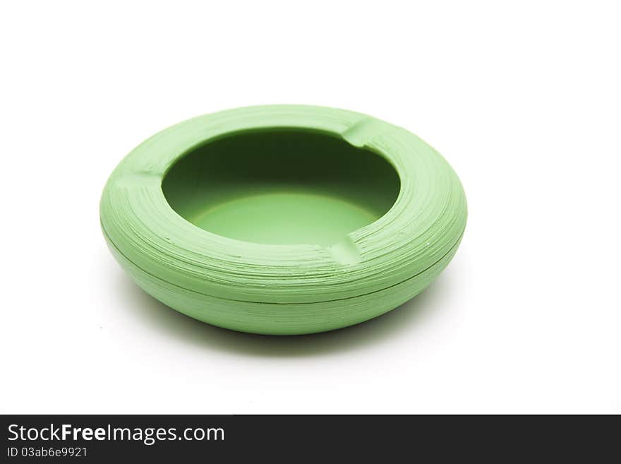 Green ashtray from ceramics onto white background