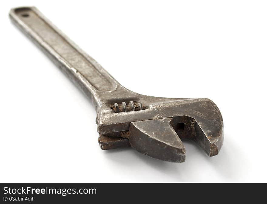 Old wrench on a white background, close-up.