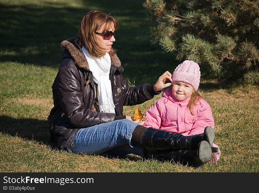 Mum with a daughter in autumn park