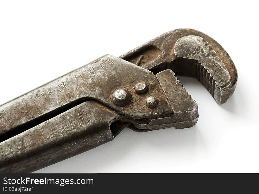 Old wrench on a white background, close-up.