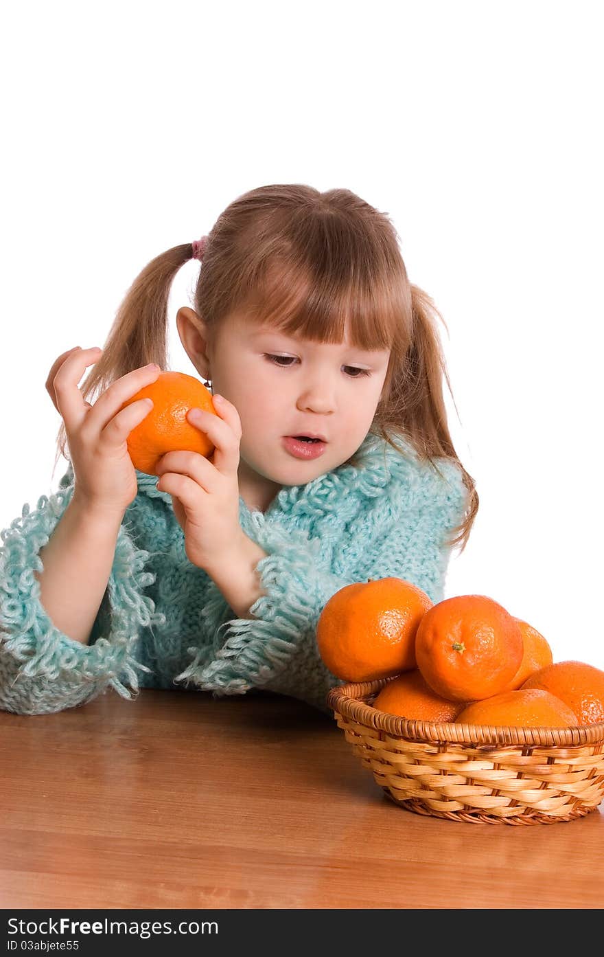 The little girl with tangerines on white