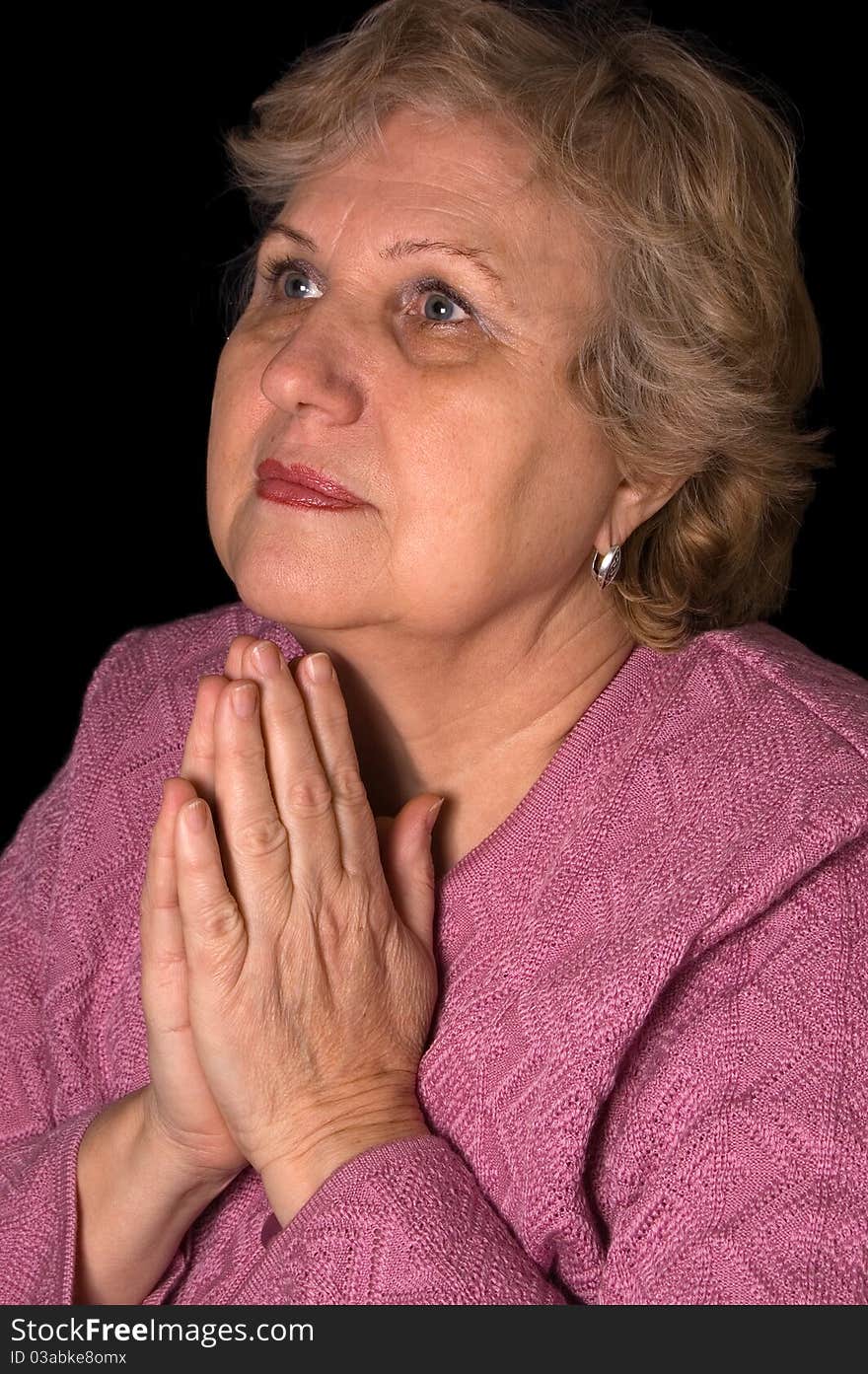 The elderly woman on black background