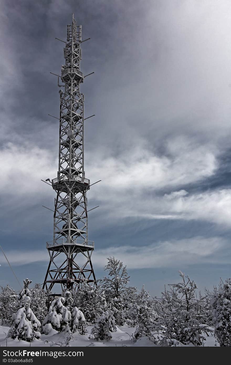 Telecommunication tower with antennas in the winter time.