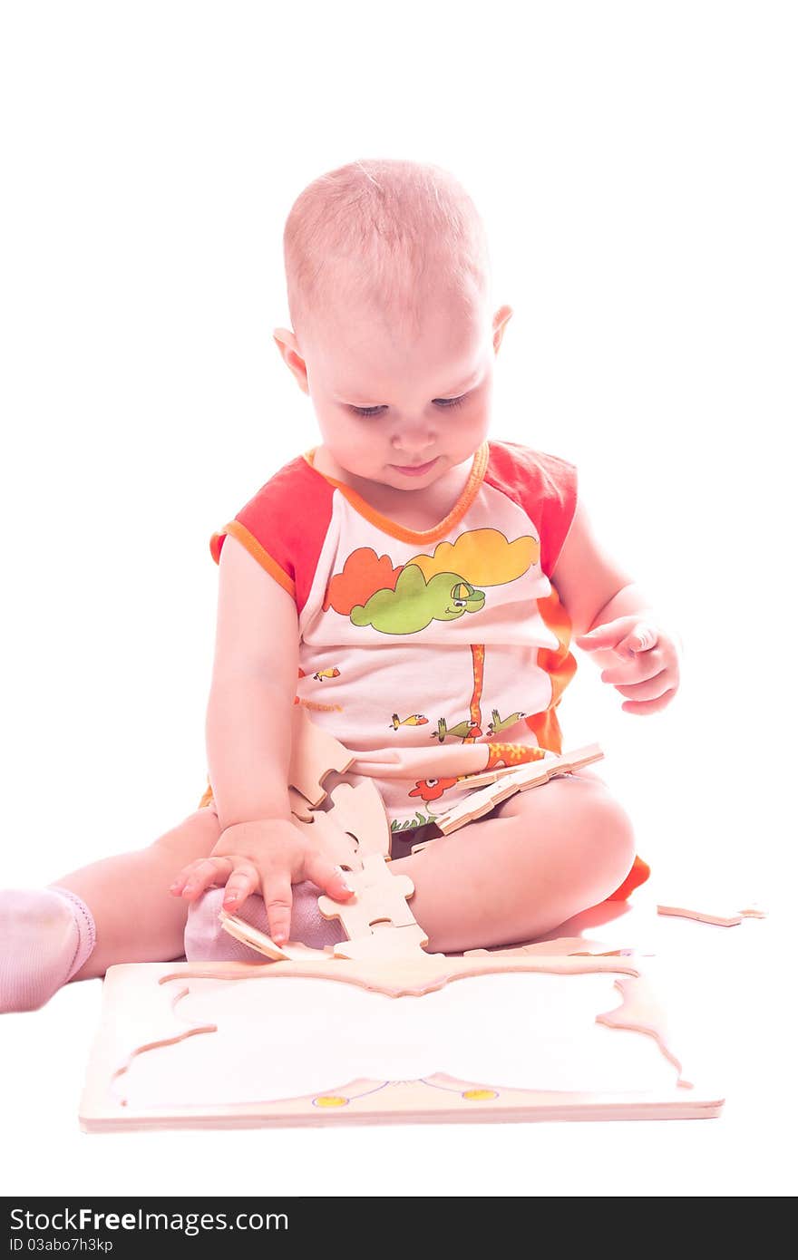 Sitting baby playing with toy isolated on white. Sitting baby playing with toy isolated on white