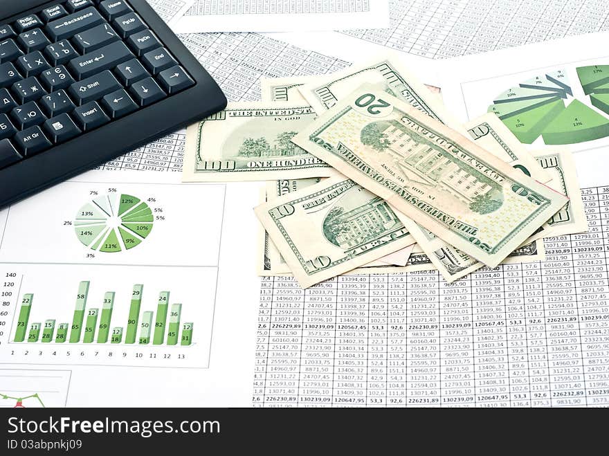 Black keyboard, mouse and dollars on a stock chart. Black keyboard, mouse and dollars on a stock chart