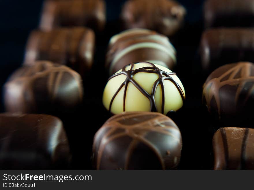 Delicious chocolates A white one is in sharp focus.