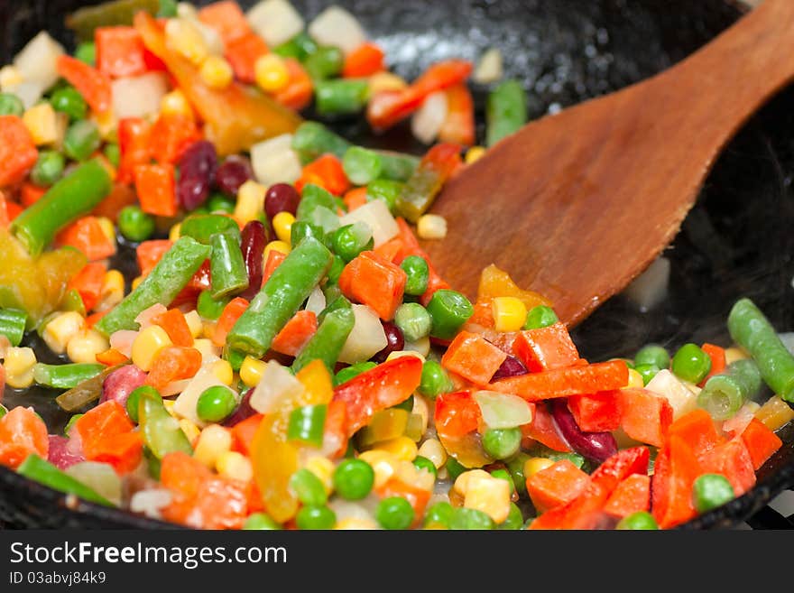 Chopped vegetables frying on a frying pan