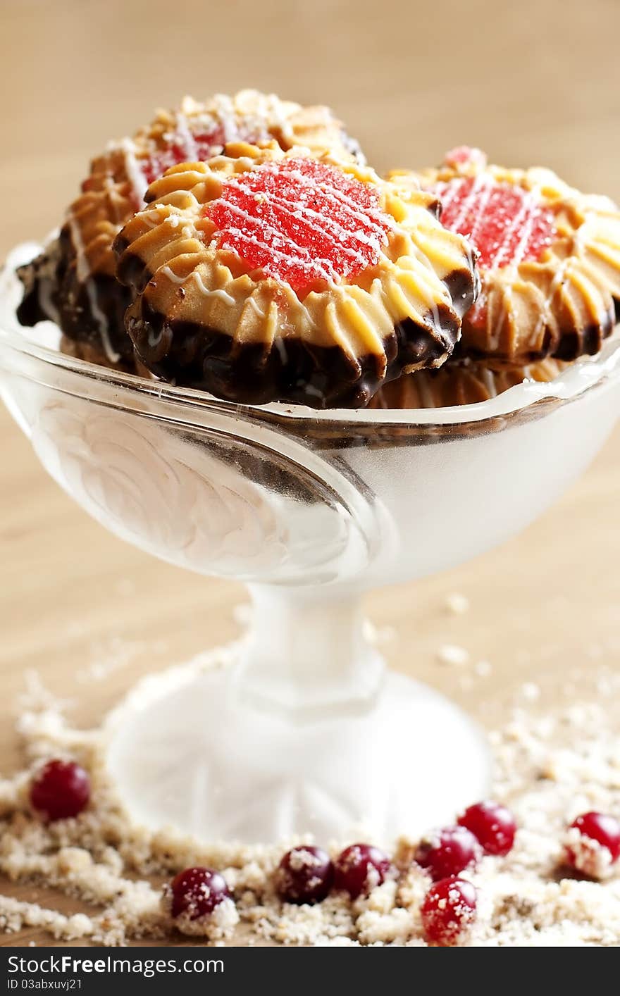 Butter cookie into a glass bowl on a wooden surface