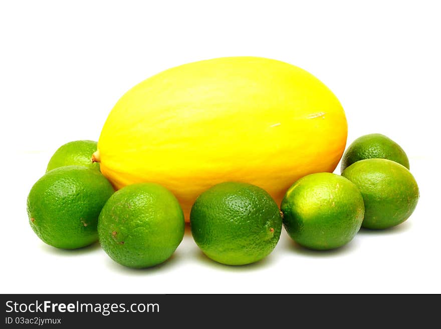 Yellow melon with green laime isolated on white