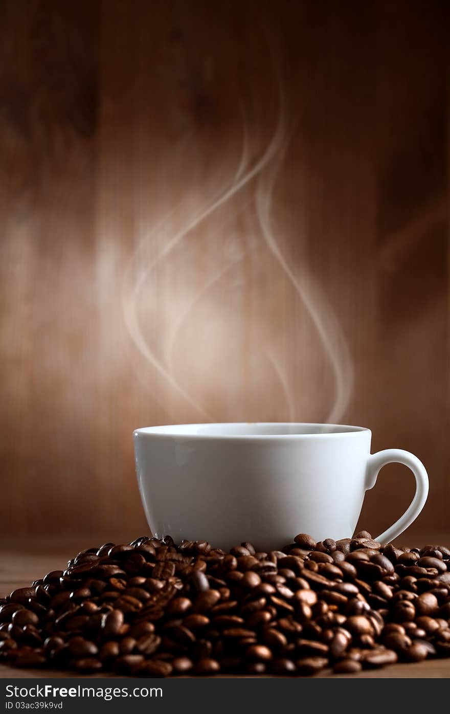 Warm cup of ciffee on brown background