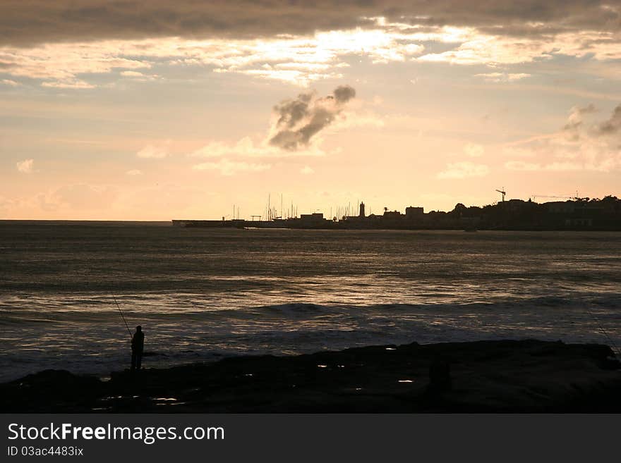 Fishing on a beautiful sunset in Estoril, Portugal