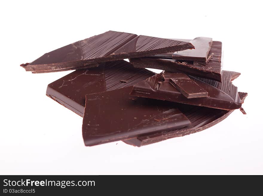 Chopped black chocolate over white background. Chopped black chocolate over white background