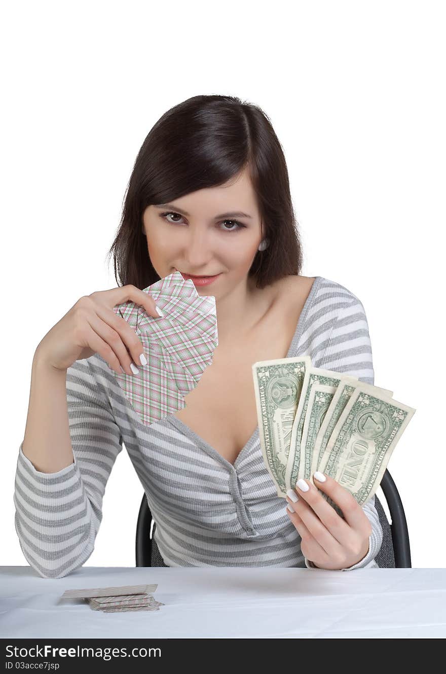 The beautiful girl happy with the cards has control over the won money. The beautiful girl happy with the cards has control over the won money