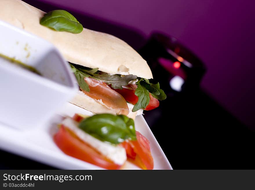 Long baguette sandwich with ham, fresh vegetables and pesto. Long baguette sandwich with ham, fresh vegetables and pesto