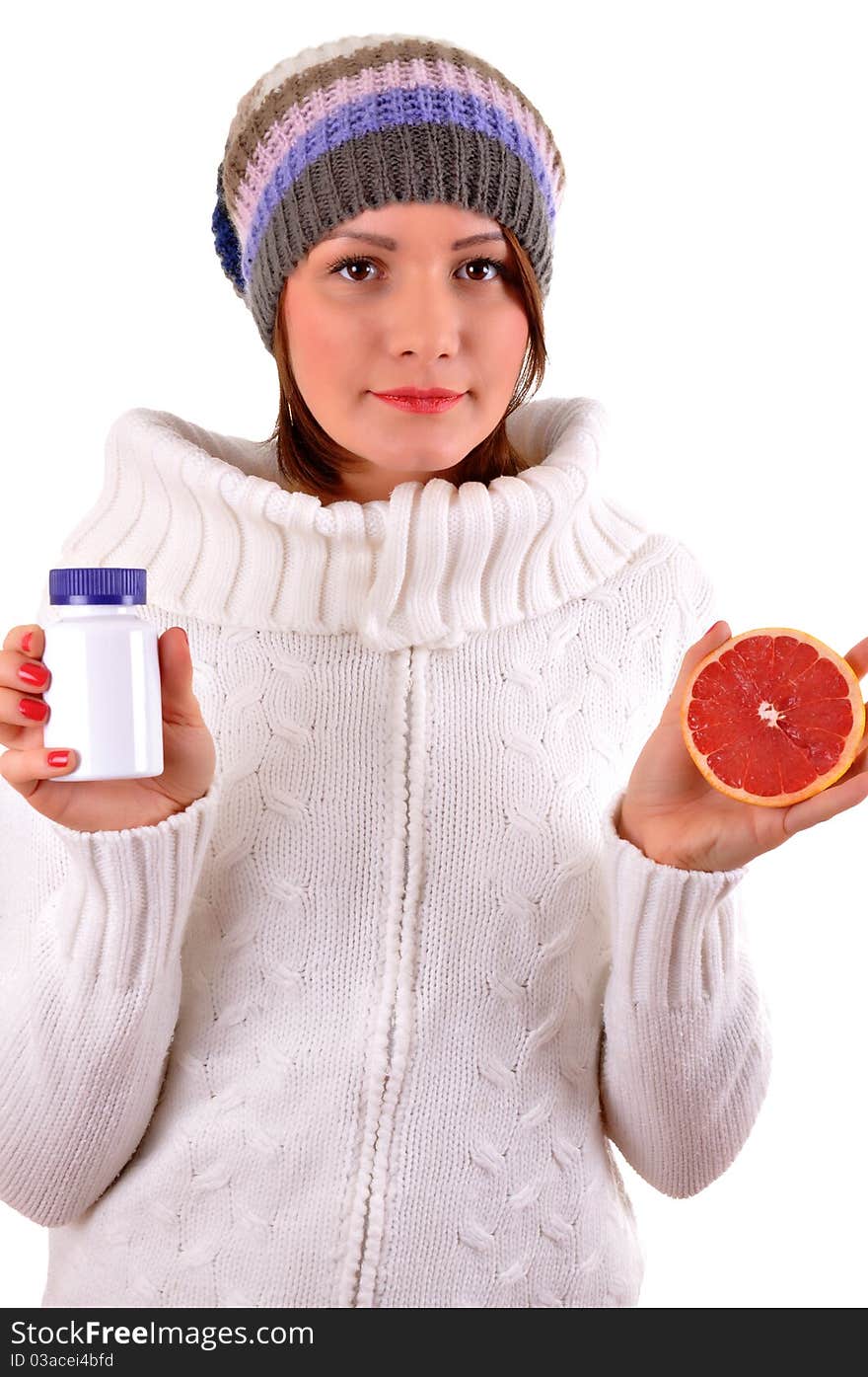 Woman's hands with orange and tablets