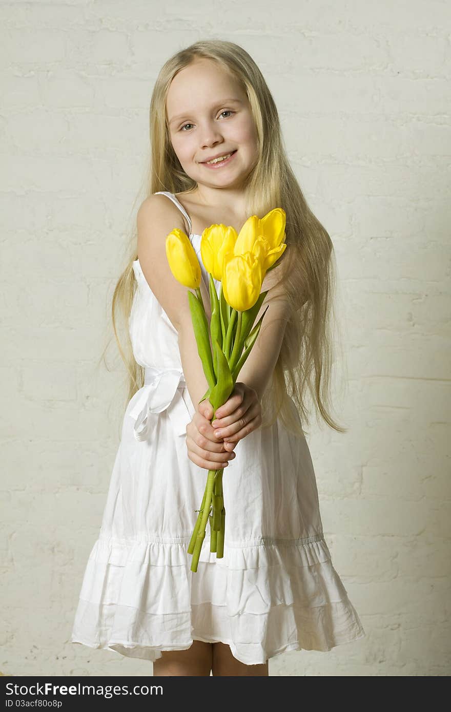 Young smiling girl with yellow flowers