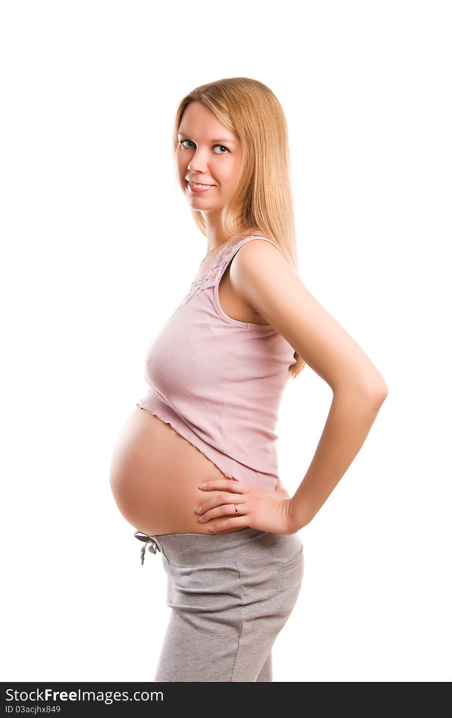 Beautiful young pregnant blond girl on white background