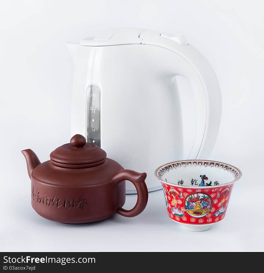 Traditional Chinese teapot, cups and kettle on a white background