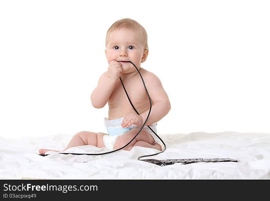 Little baby boy with a computer keyboard isolated on white