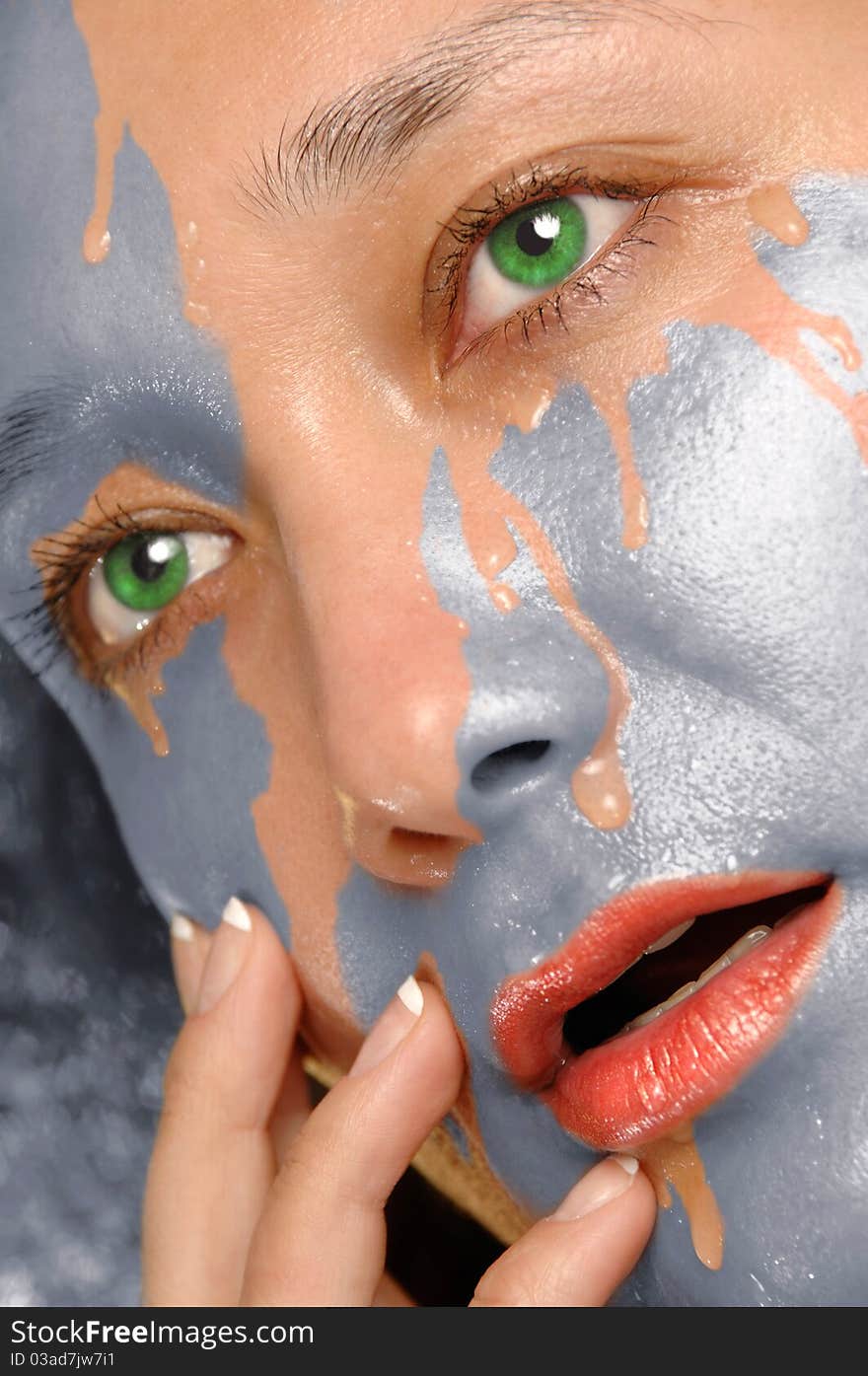 Water washing paint from woman face