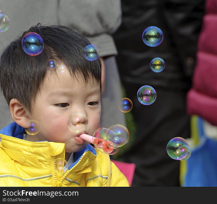 A child blowing soap bubbles. A child blowing soap bubbles