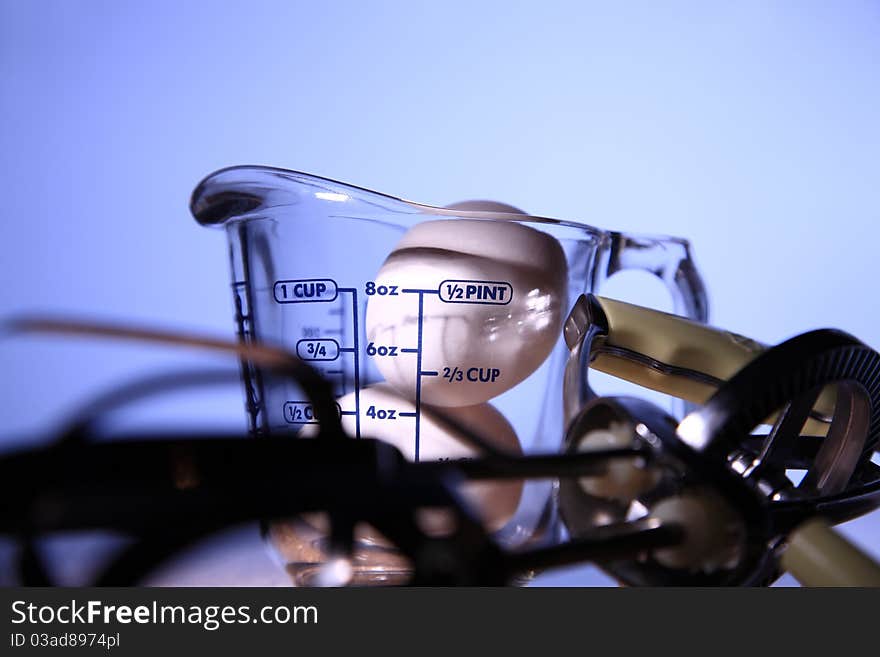 Two Eggs In Cup Isolated With Blue Background