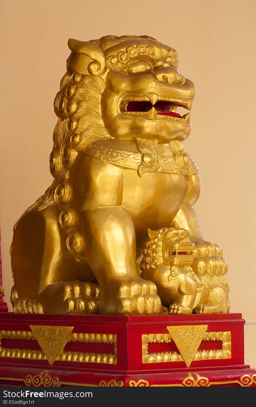 A female chinese lion and its cub in front of a church in Bangkok Thailand.