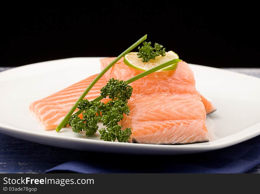 Photo of delicious salmon fillet with parsley and lime. Photo of delicious salmon fillet with parsley and lime