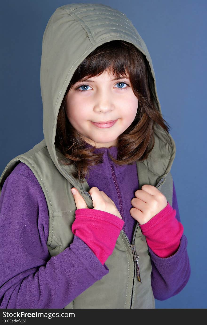 Smiling little child posing isolated on blue background