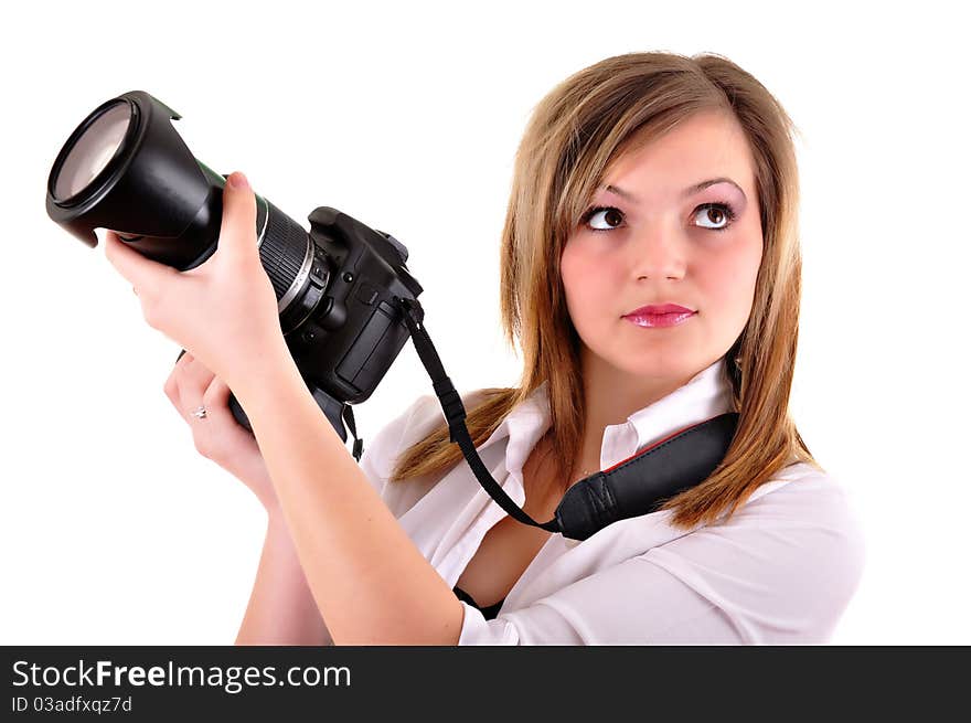 Young woman with photographic camera on white background