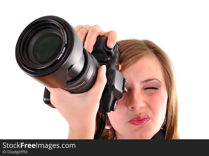 Young woman with photographic camera on white background