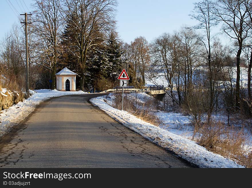 Winter road on a sunny frosty day with blue sky