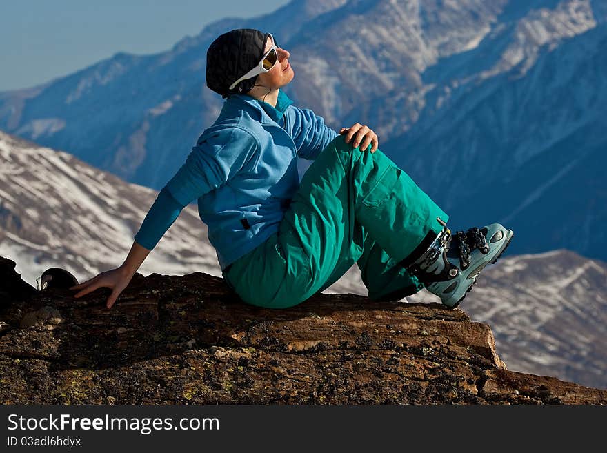 Young woman on the top of the mountain