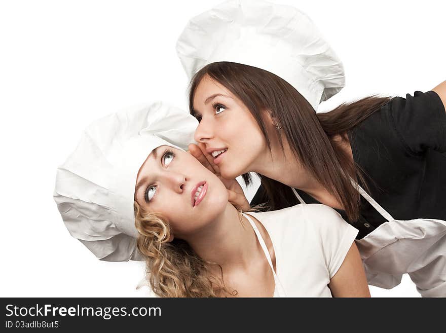 Two young female cookers sharing their secrets, studio shot