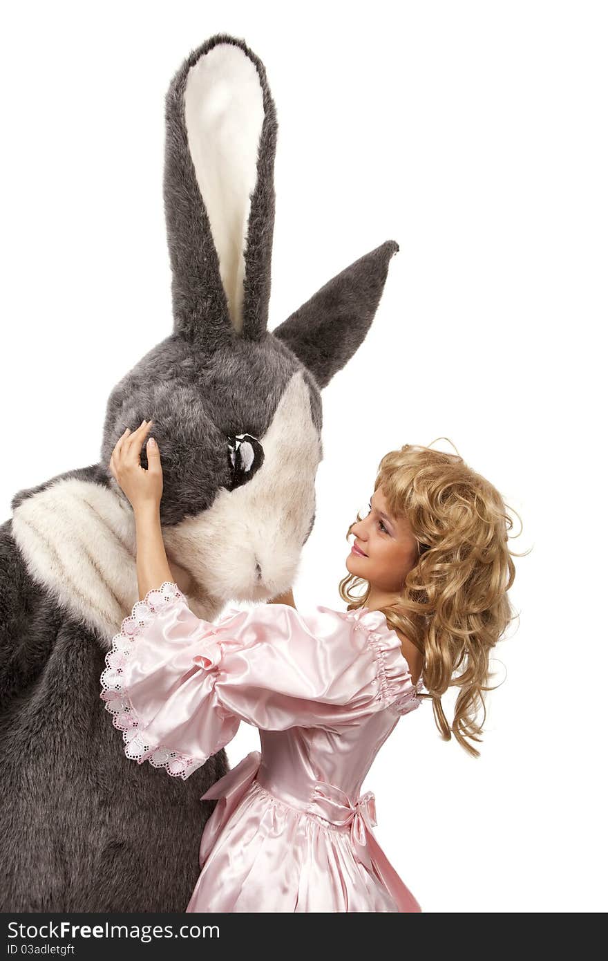 Close-up portrait of a pretty girl in pink dress with a big grey fur's color rabbit against white background. Close-up portrait of a pretty girl in pink dress with a big grey fur's color rabbit against white background