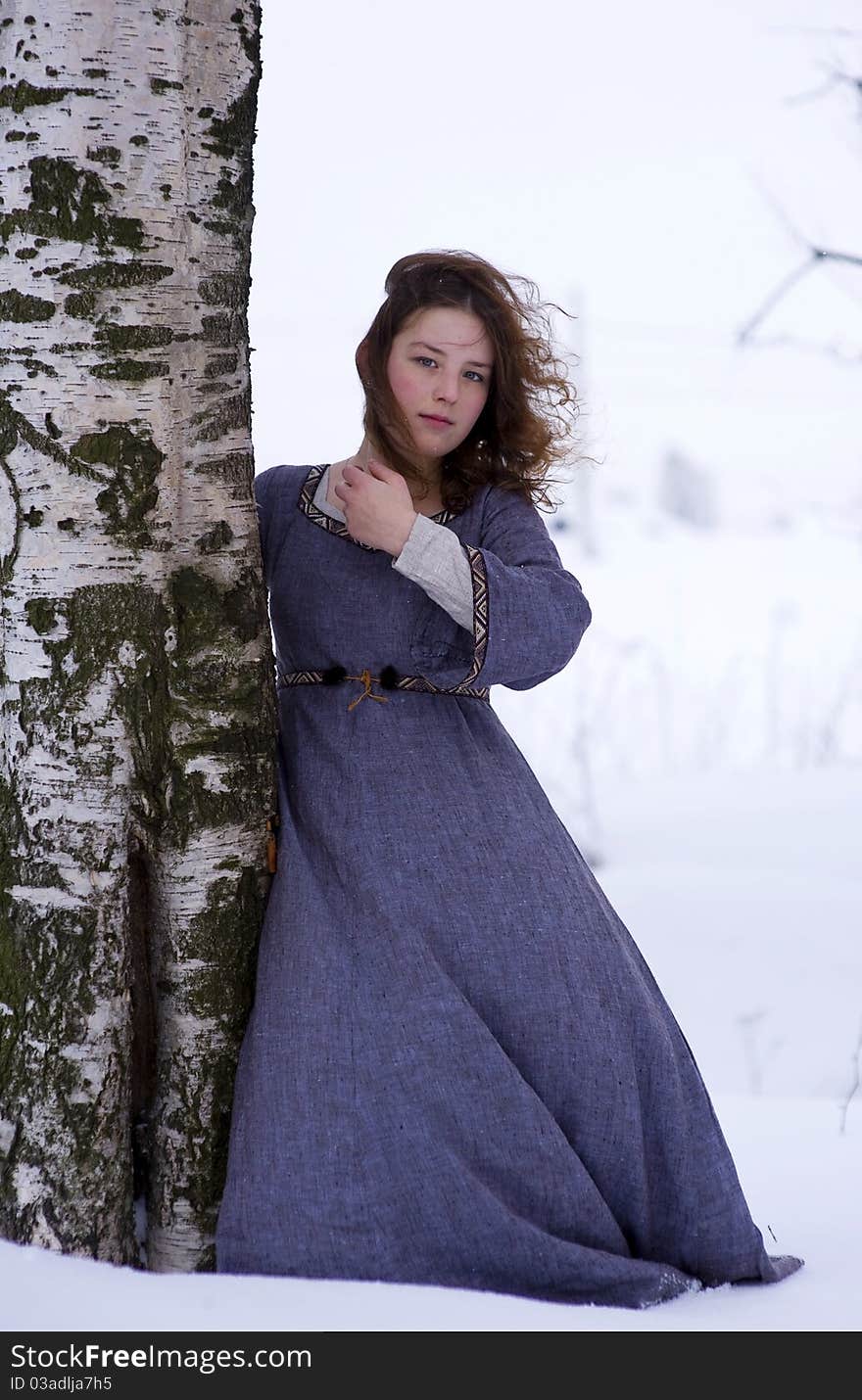 Girl in medieval dress with the tree