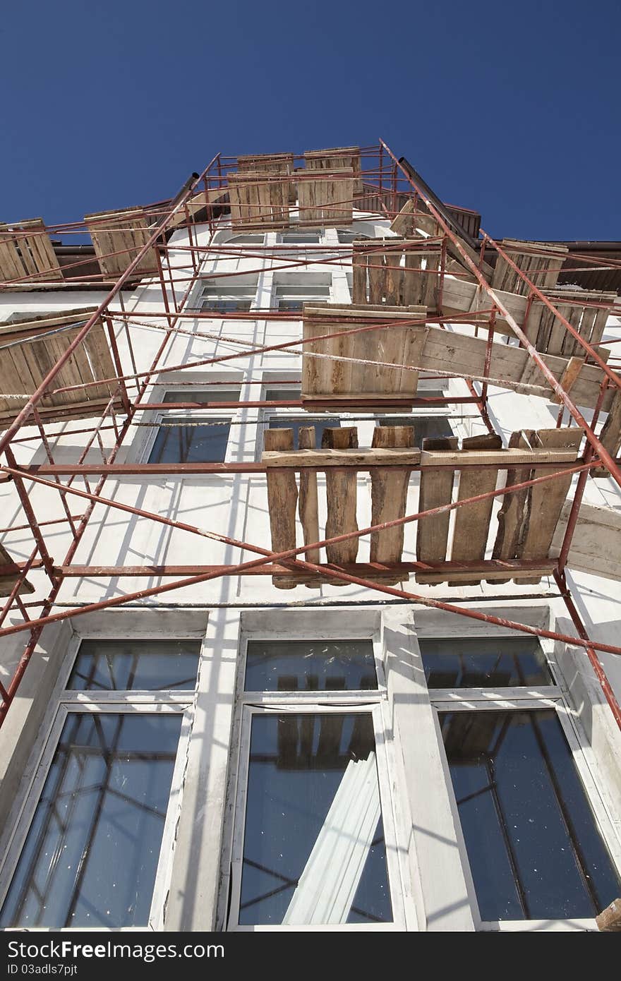 Construction. Residential building scaffolding construction background