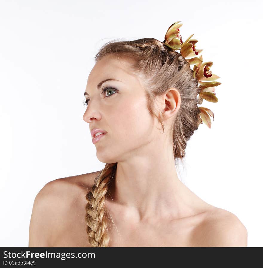 Portrait of the beauty young blond girl with orchid in her hair