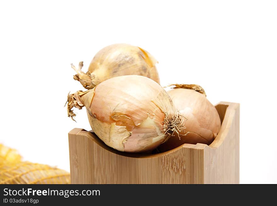 Raw onion in the wood receptacle