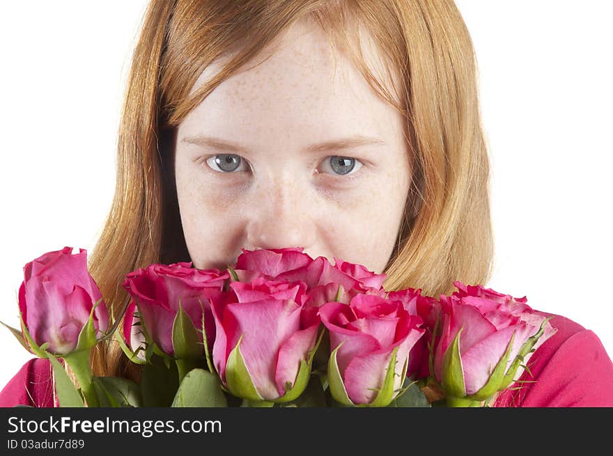 Young Girl Is Smelling At Beautiful Pink Roses