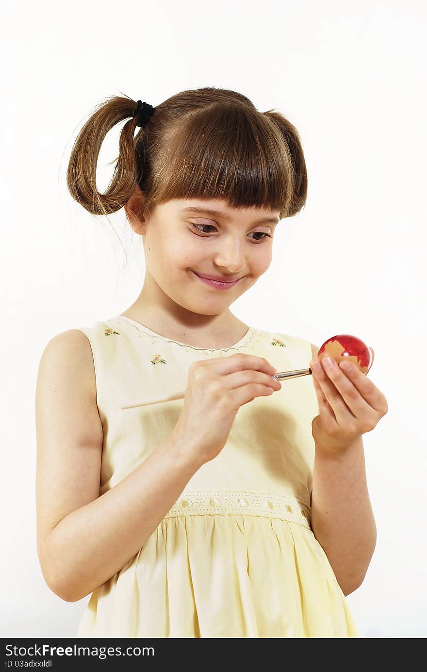 Girl painting Easter painted eggs with the brush. Girl painting Easter painted eggs with the brush