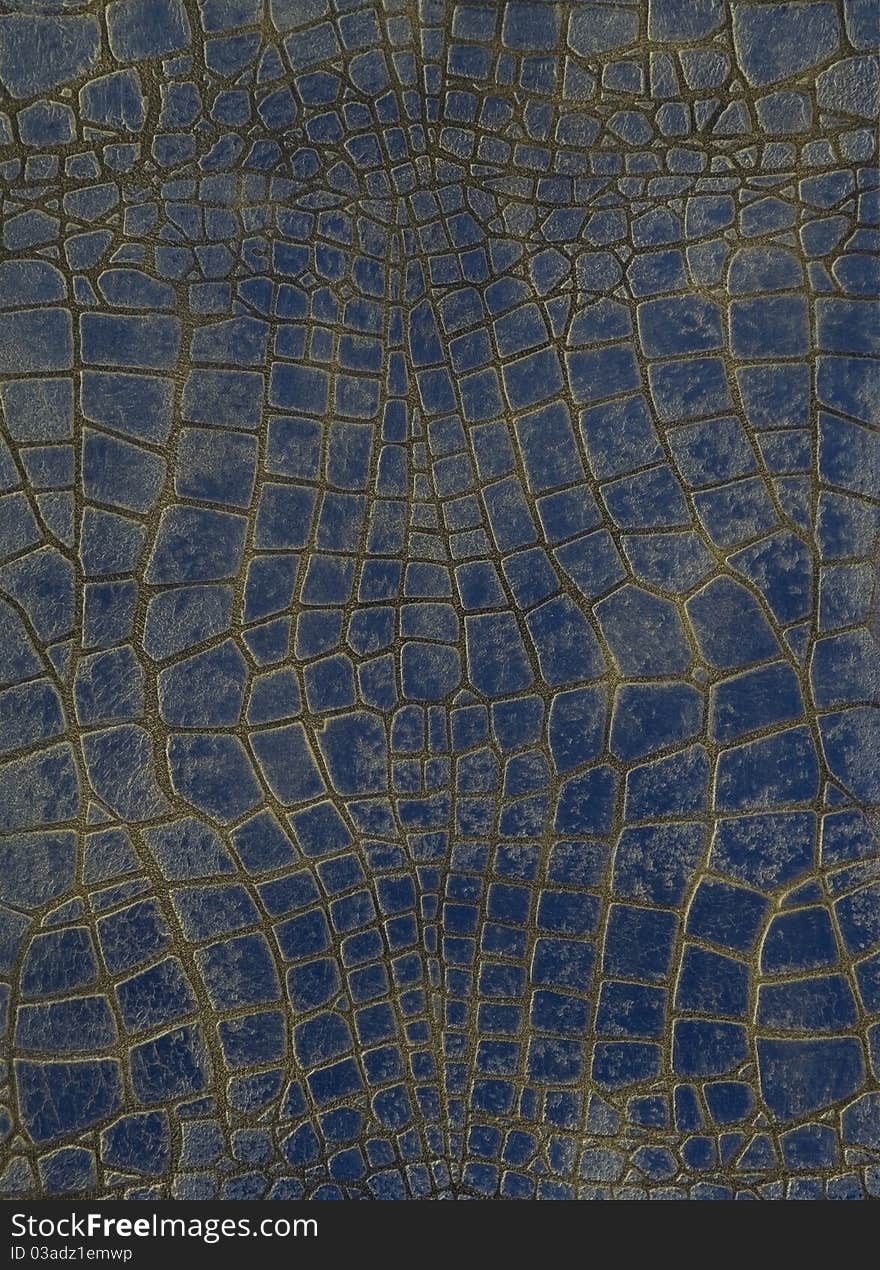 Fragment of the painted stone wall, made as a crocodile skin, in dark blue color. Fragment of the painted stone wall, made as a crocodile skin, in dark blue color