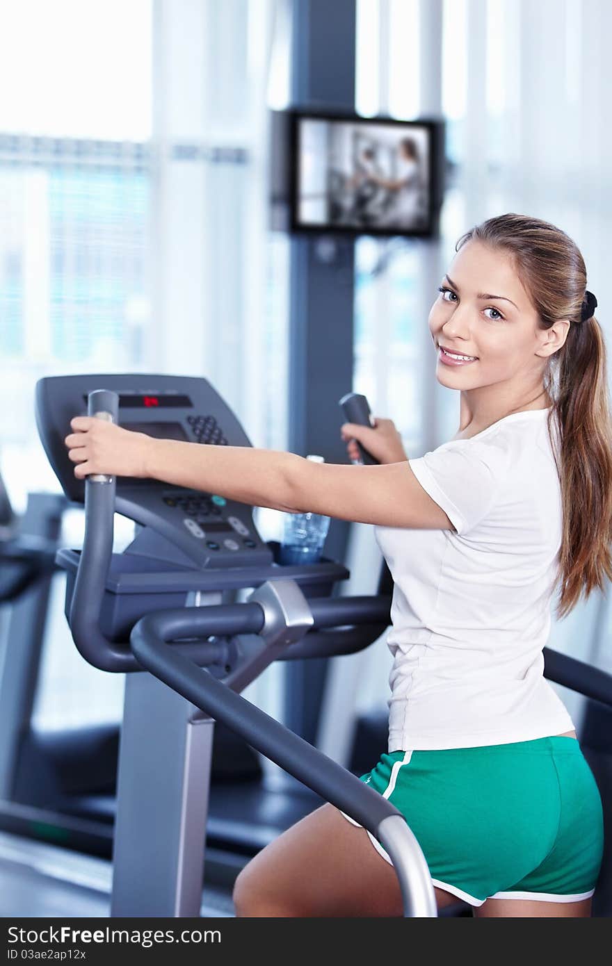 Young attractive girl involved in the simulator. Young attractive girl involved in the simulator