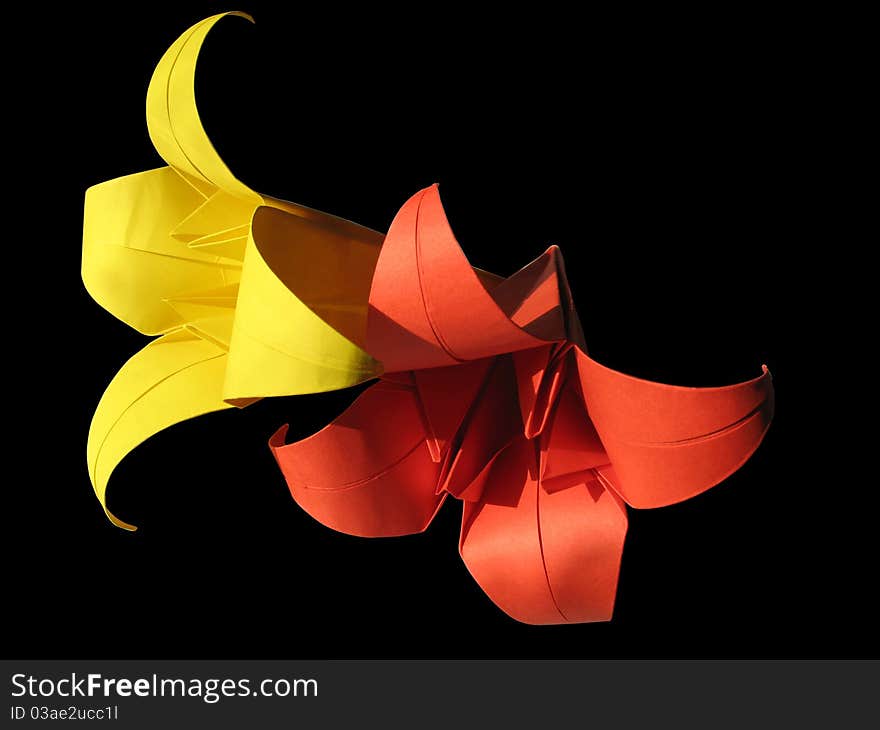 Origami red & yellow flower isolated on black