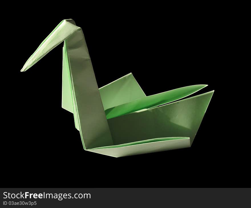 Origami green swan isolated on black