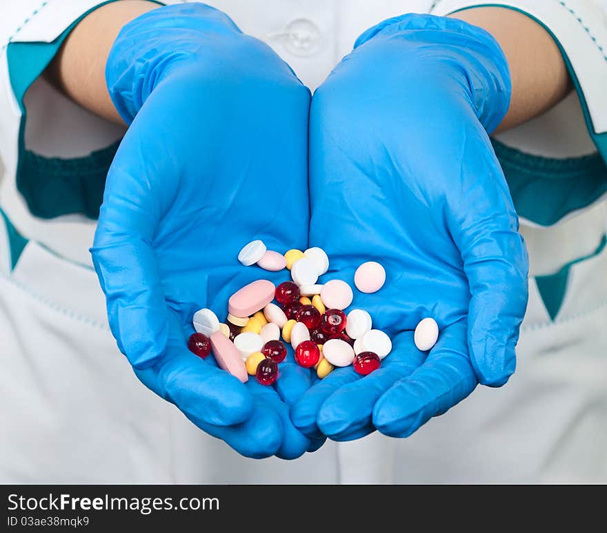 Drugs in the hands of a doctor on a white background