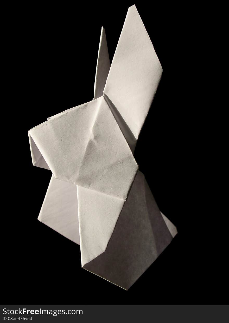 Origami white hare isolated on black